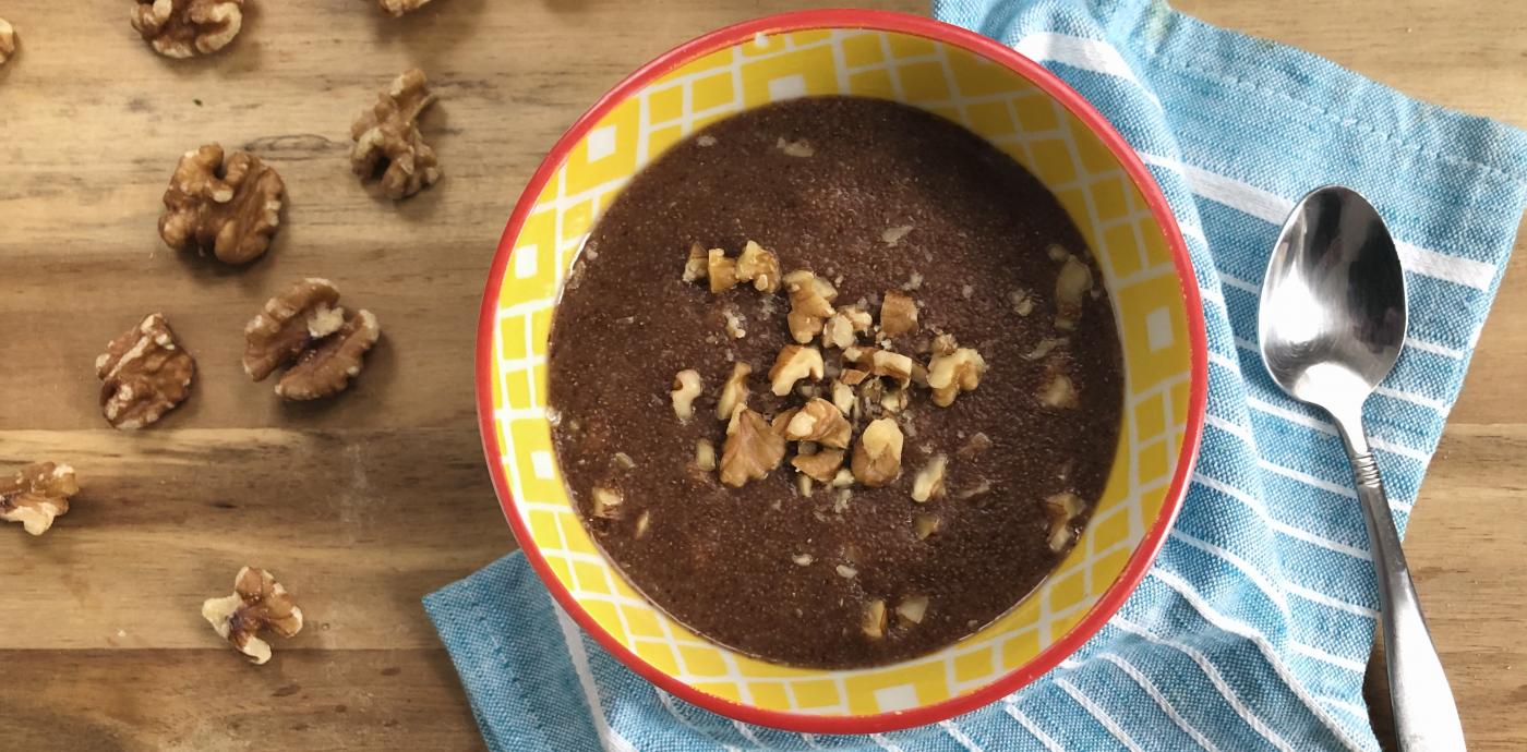 a bowl of chocolatey looking porridge in a yellow bowl