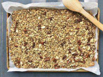 granola displayed on a parchment-lined baking sheet