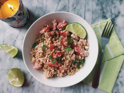 bowl of farro salad with strawberries, mint, and lime