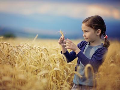 Girl with Pink Ribbon in field of wheat