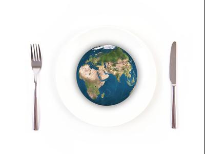 Picture of globe on a plate with a fork and knife