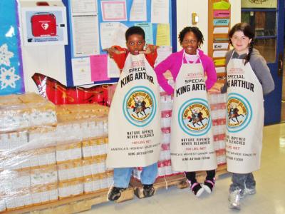 School children celebrate donated bags of whole wheat flour, courtesy of King Arthur Flour