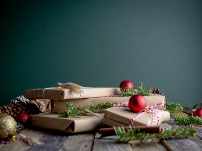 Brown-paper wrapped presents with winter greenery