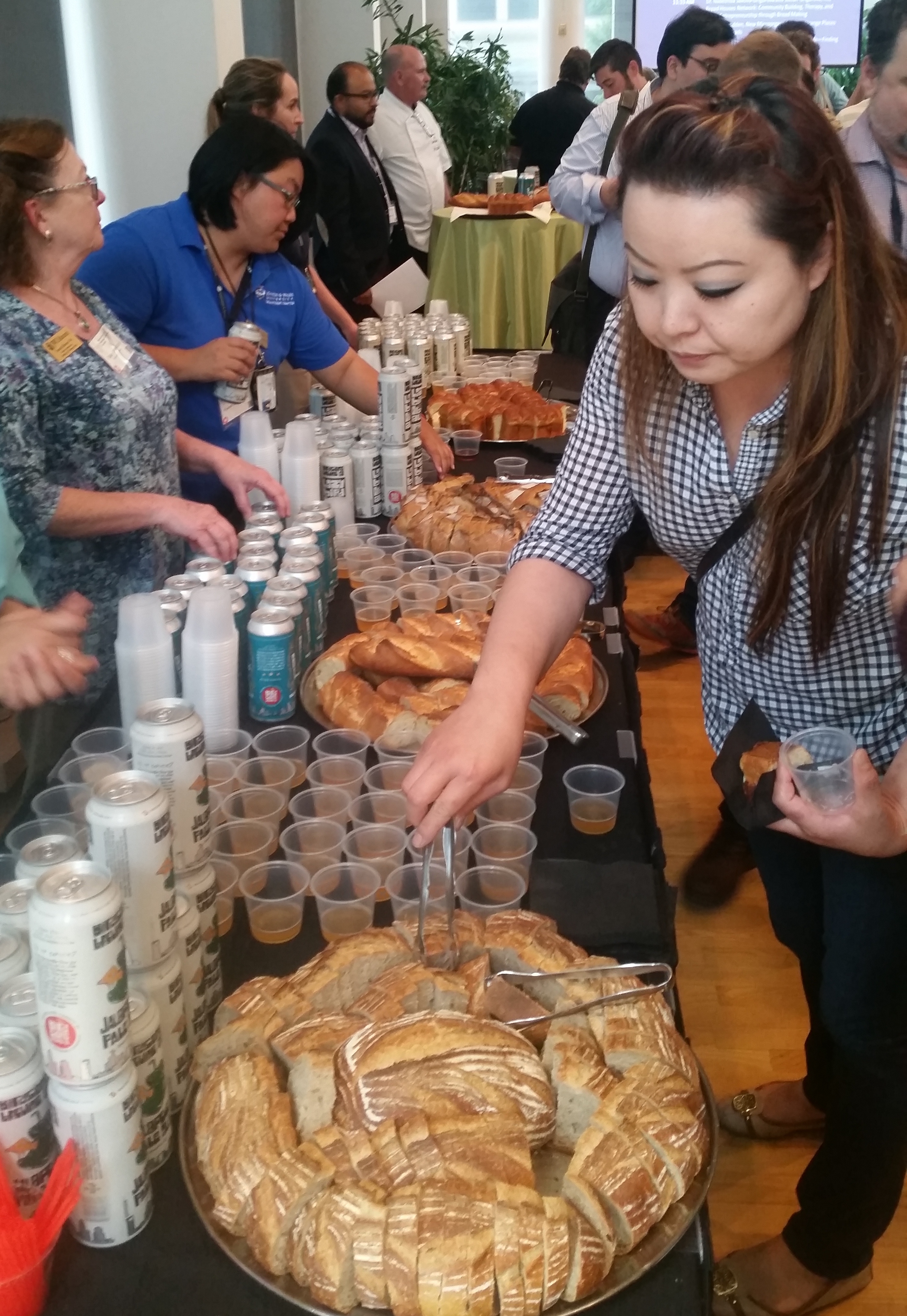 A woman sampling bread and beer