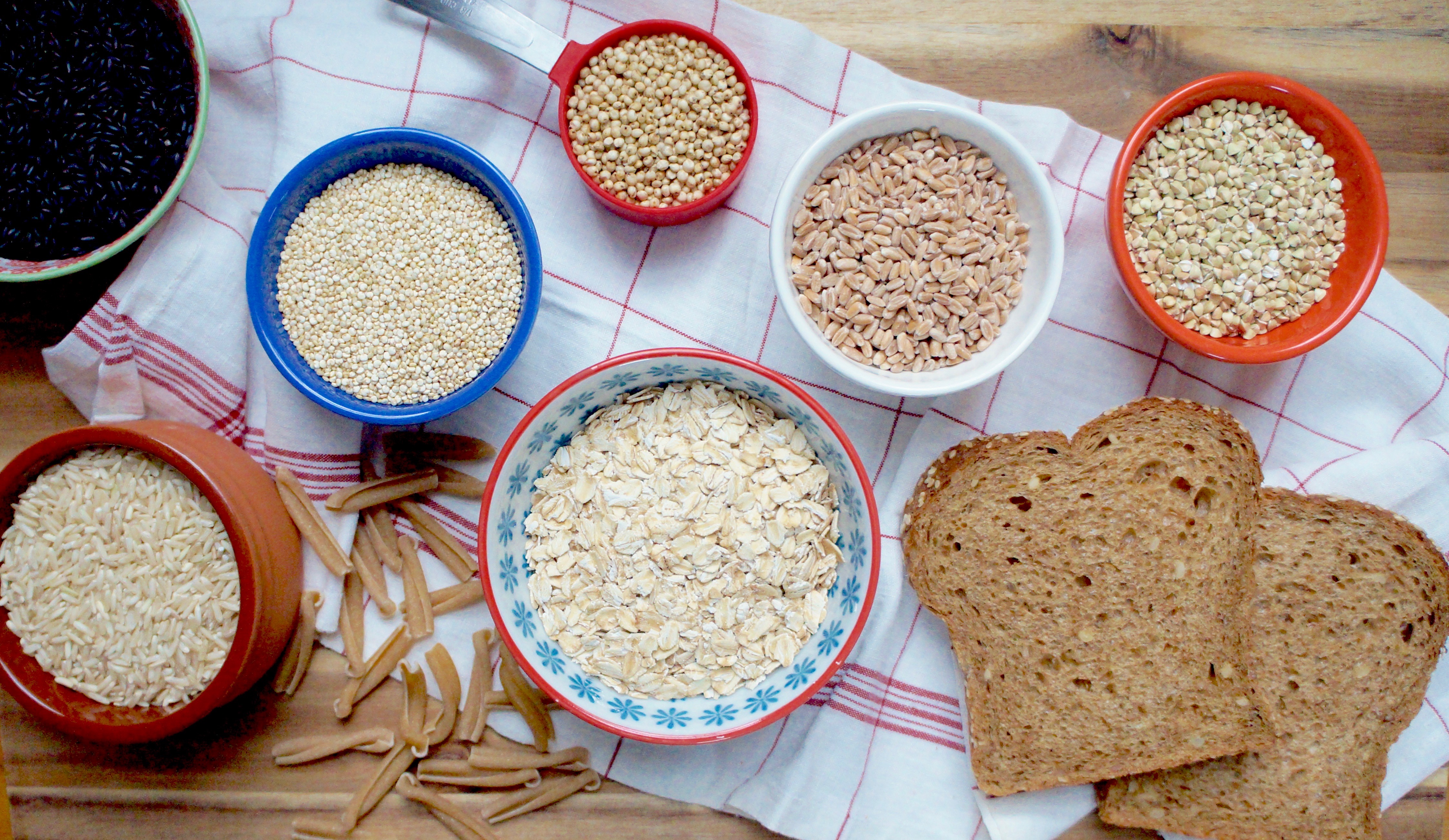 Assorted Grains in bowls and slices of bread