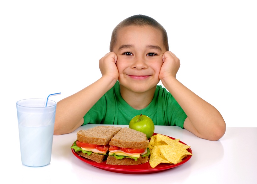 Child eating whole grain sandwich 