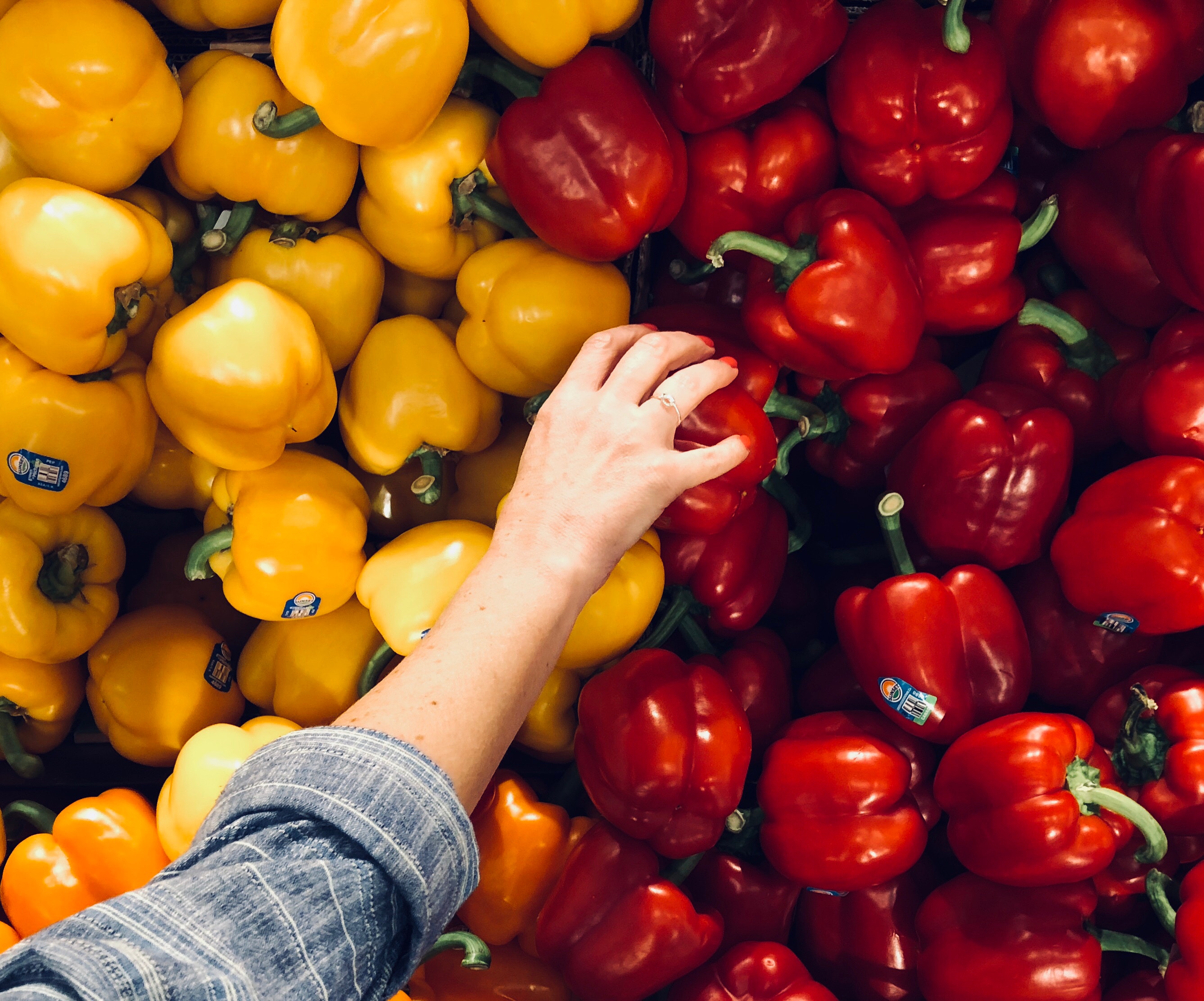 Woman reaching for red pepper