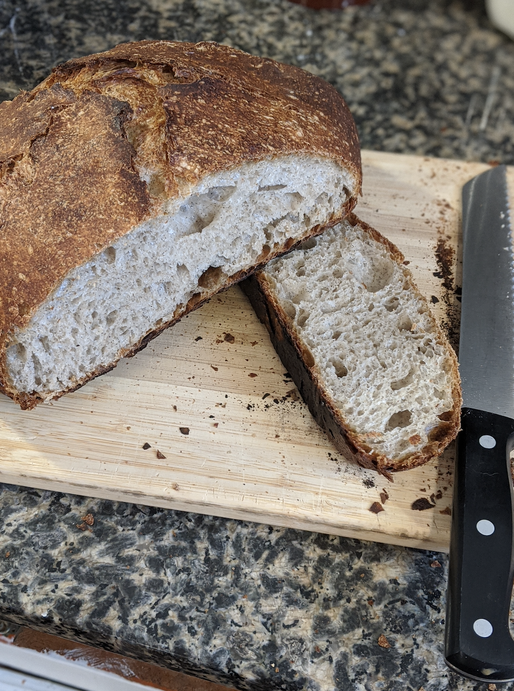 whole grain sourdough bread on a cutting board