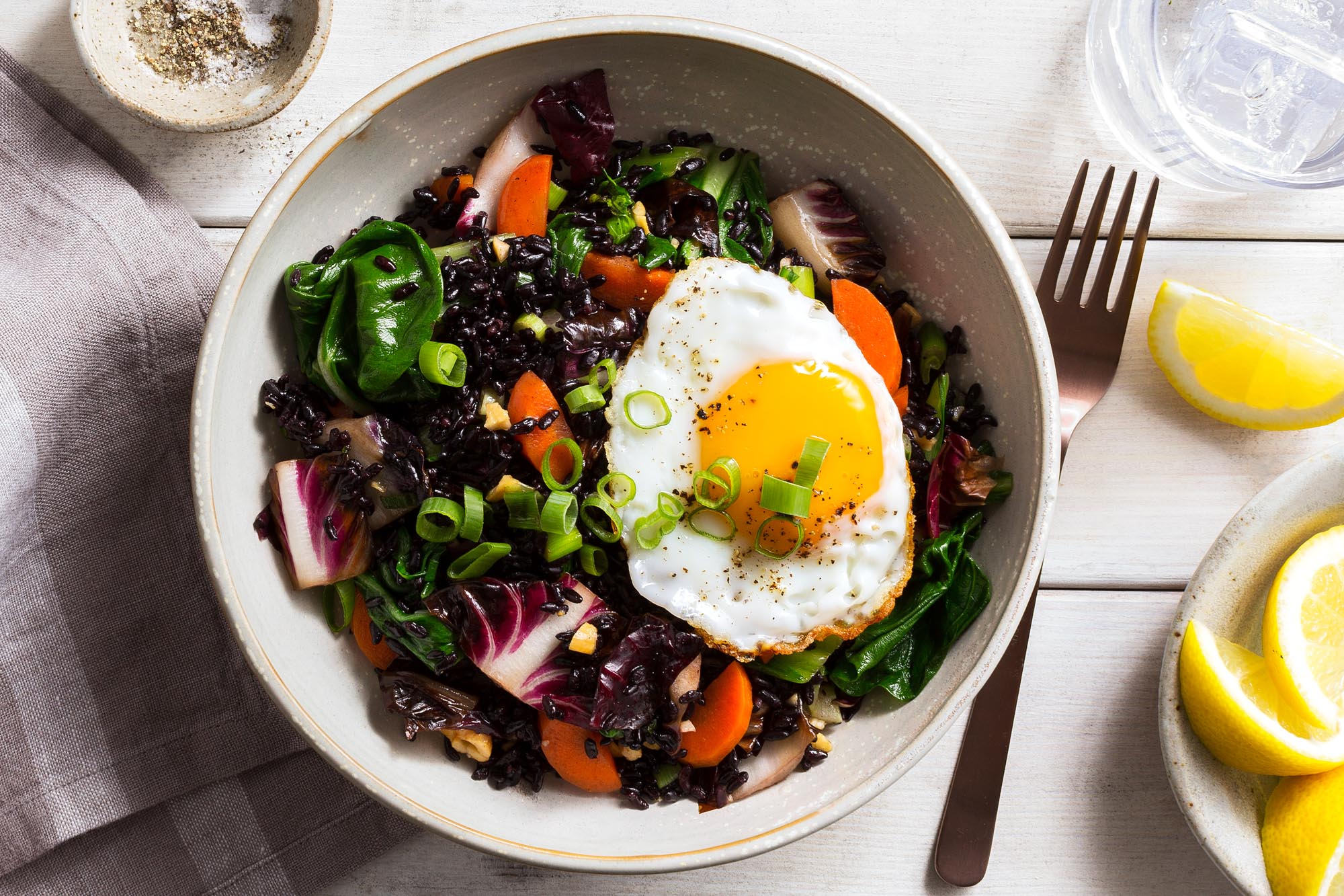 Thai stir-fry with bok choy, black rice, and fried eggs