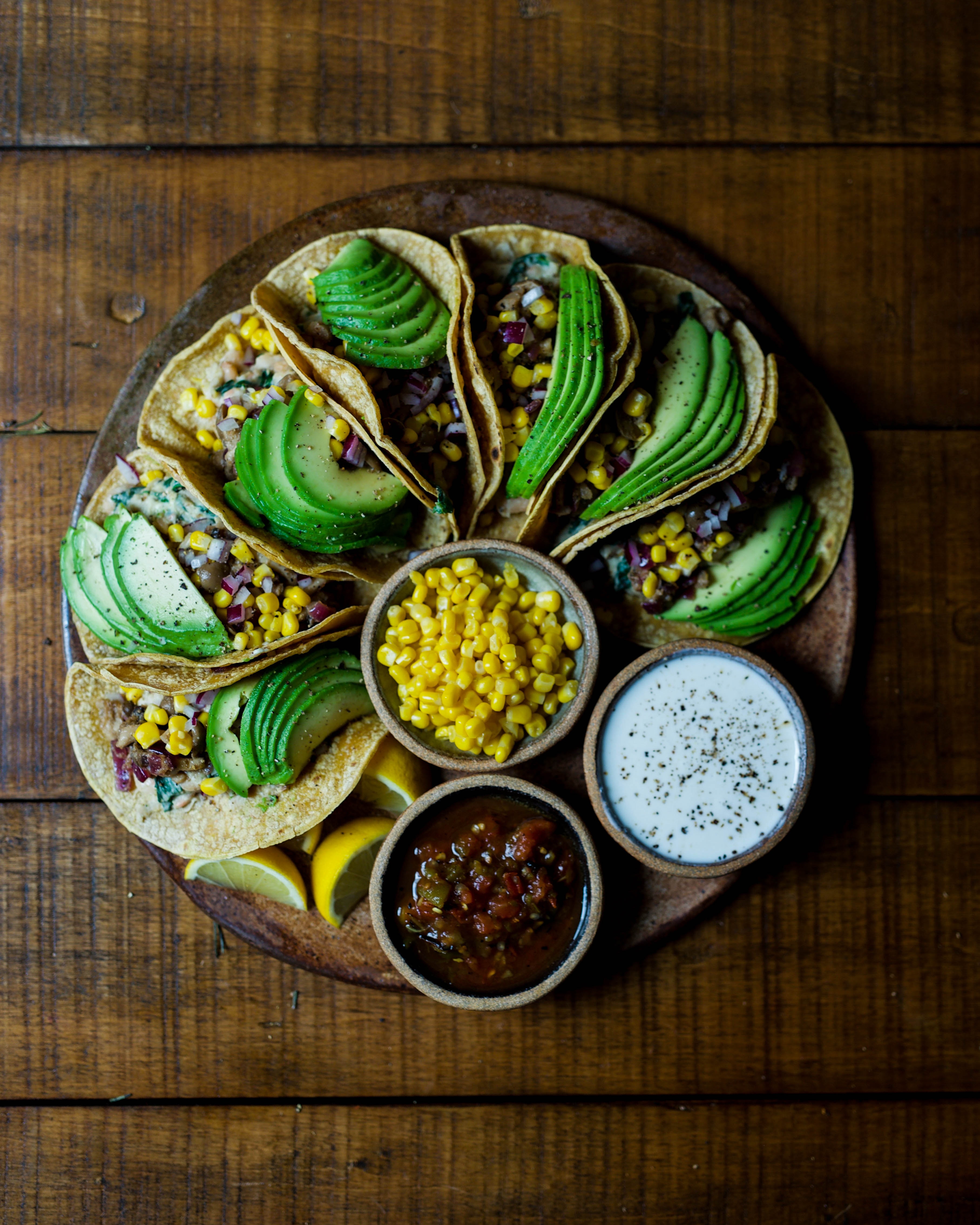 Avocado tacos arranged on a brown plate